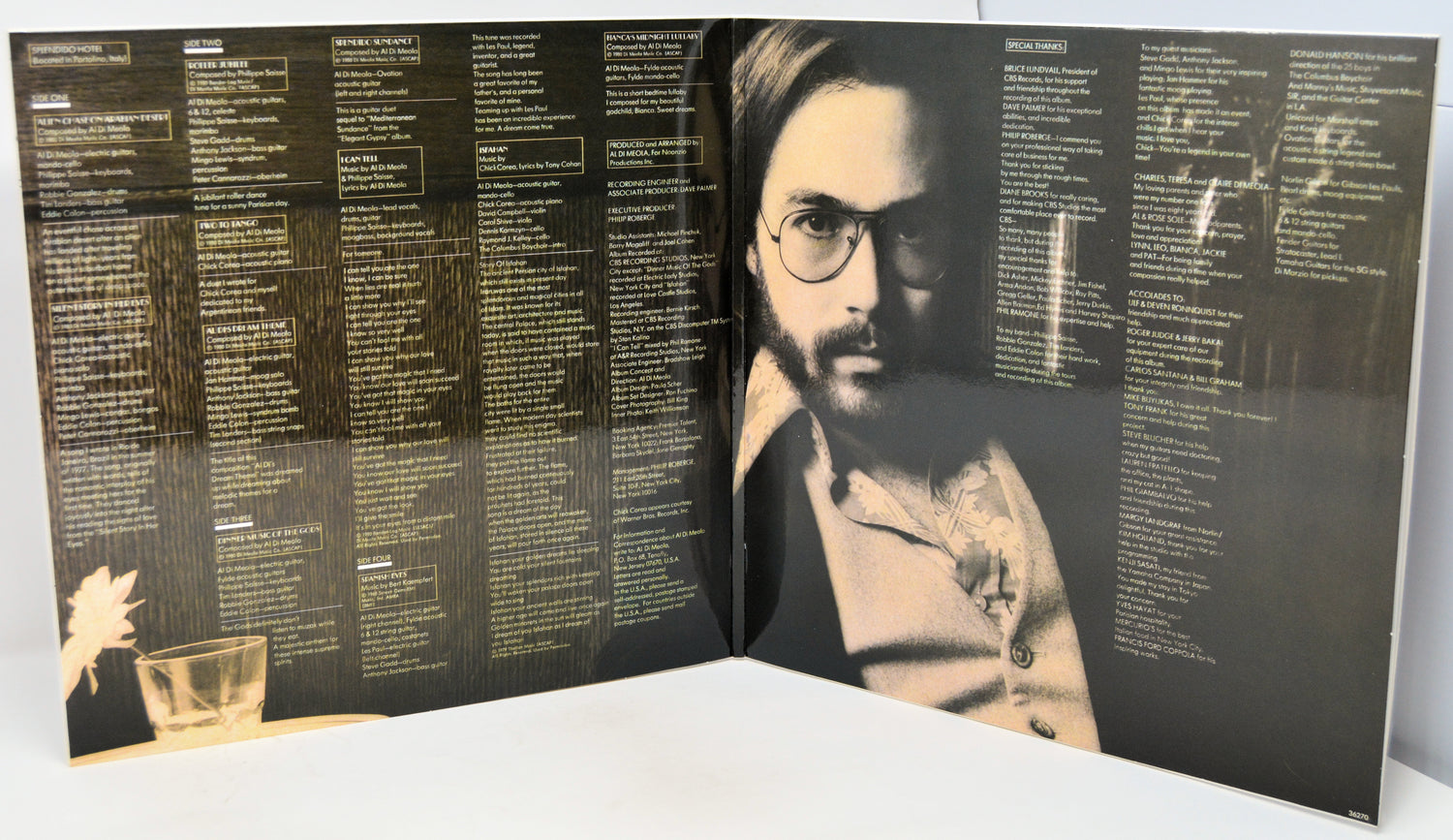An open vinyl record sleeve or booklet showing printed track listings and a black-and-white portrait of a bearded man with glasses on the right page, photographed against a plain light background.