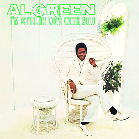 Album cover featuring a person in a white suit sitting in a wicker chair with 'Al Green I'm Still In Love With You' text.