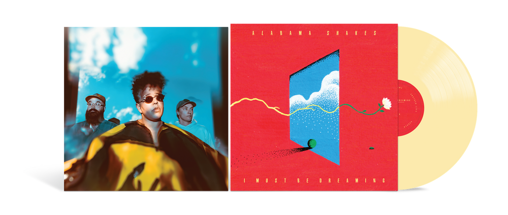 A vinyl record album shown open, with the left sleeve featuring a stylized portrait of a person against a blue sky, the center cover in bright red with a blue window illustration, and a pale yellow record partially visible on the right.