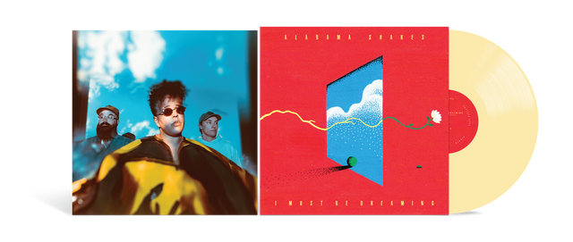 A vinyl record album shown open, with the left sleeve featuring a stylized portrait of a person against a blue sky, the center cover in bright red with a blue window illustration, and a pale yellow record partially visible on the right.