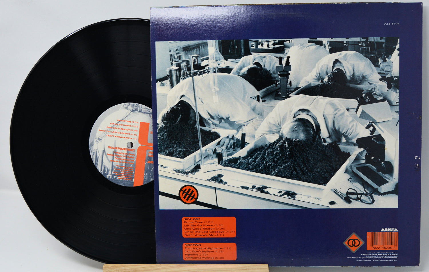 Vinyl record with a detailed cover showing a factory scene.