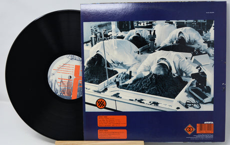 Vinyl record with a detailed cover showing a factory scene.