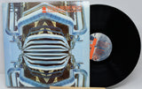 Vinyl record with a futuristic album cover featuring blue and white design.