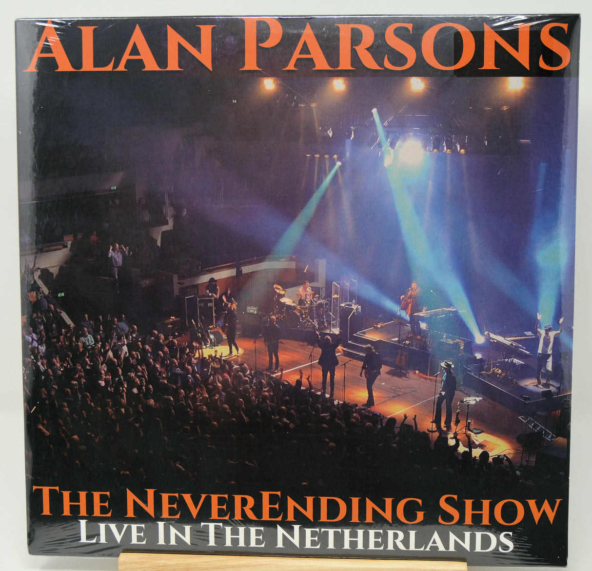 Alan Parsons 'The NeverEnding Show Live in the Netherlands' vinyl record cover, featuring a live concert stage scene with blue and orange stage lights and a crowd in the foreground.