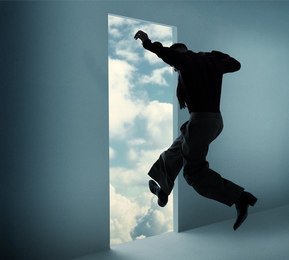Close-up of surreal album cover art showing a person stepping through a doorway into clouds