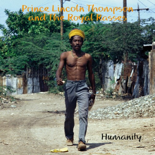 Prince Lincoln Thompson walking shirtless on a rustic street, album cover for 'Humanity' by The Royal Rasses