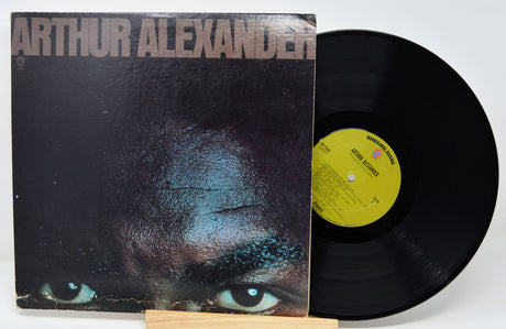 Vinyl record with cover featuring a close-up of a person's face and 'Arthur Alexander' text.