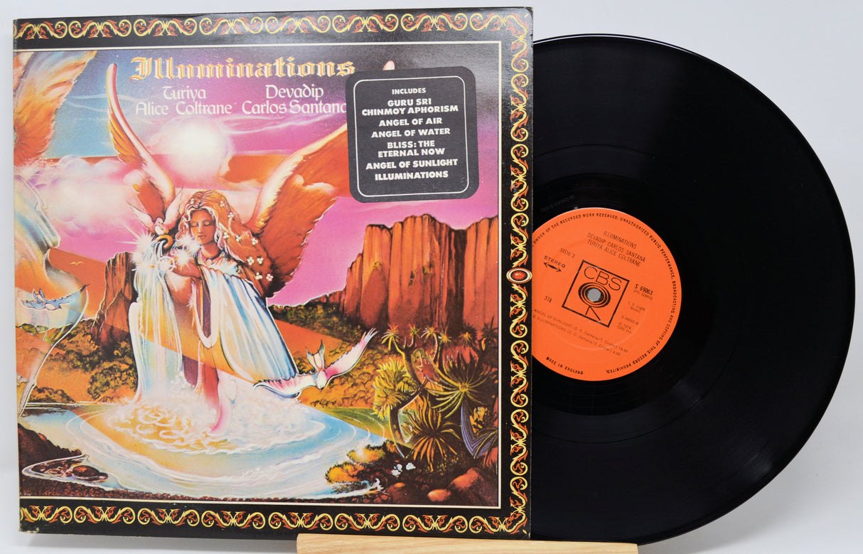 A vinyl record album shown with its illustrated outer sleeve and the black record partially pulled out. The sleeve features a colorful fantasy-style illustration with an angel, desert landscape, and bright pink, orange, yellow, and blue tones.