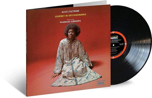 Vinyl record with cover featuring a person sitting on a red background