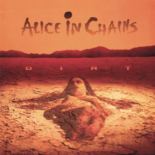 Album cover for 'Dirt' by Alice in Chains with a desert landscape and person lying on the ground.