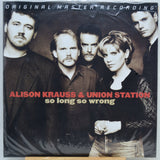 Vinyl record album cover for Alison Krauss & Union Station's 'so long so wrong', featuring a group portrait of five people against a dark studio background with red and beige text.