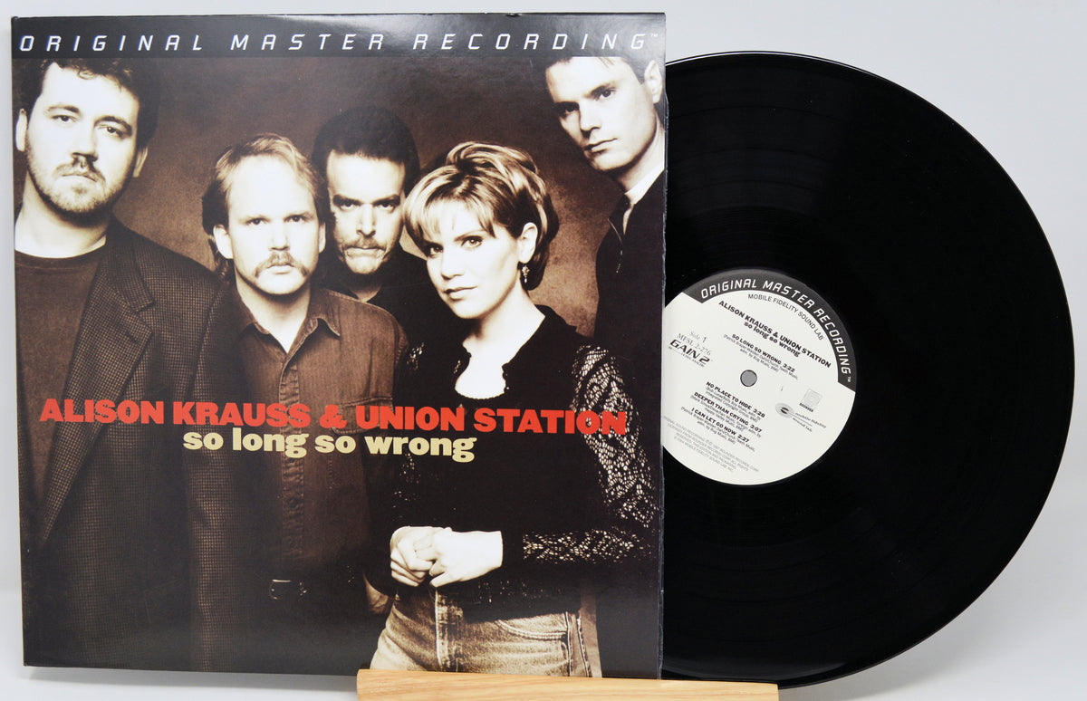 Alison Krauss & Union Station - 'So Long So Wrong' original master recording vinyl LP with the album cover standing next to the black record on a small wooden stand.