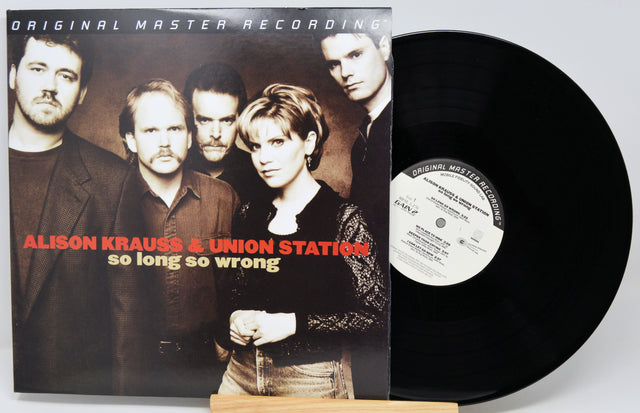 Alison Krauss & Union Station - 'So Long So Wrong' original master recording vinyl LP with the album cover standing next to the black record on a small wooden stand.