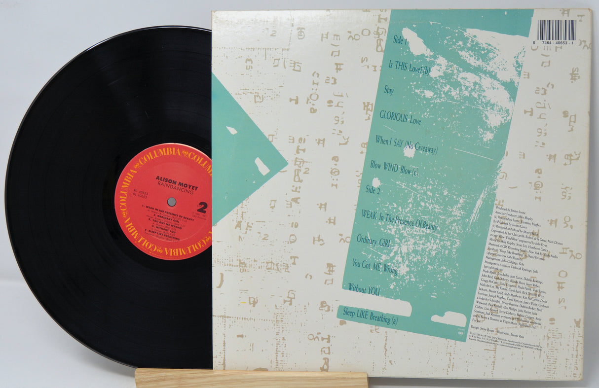 Vinyl record with a textured cover on a light gray background