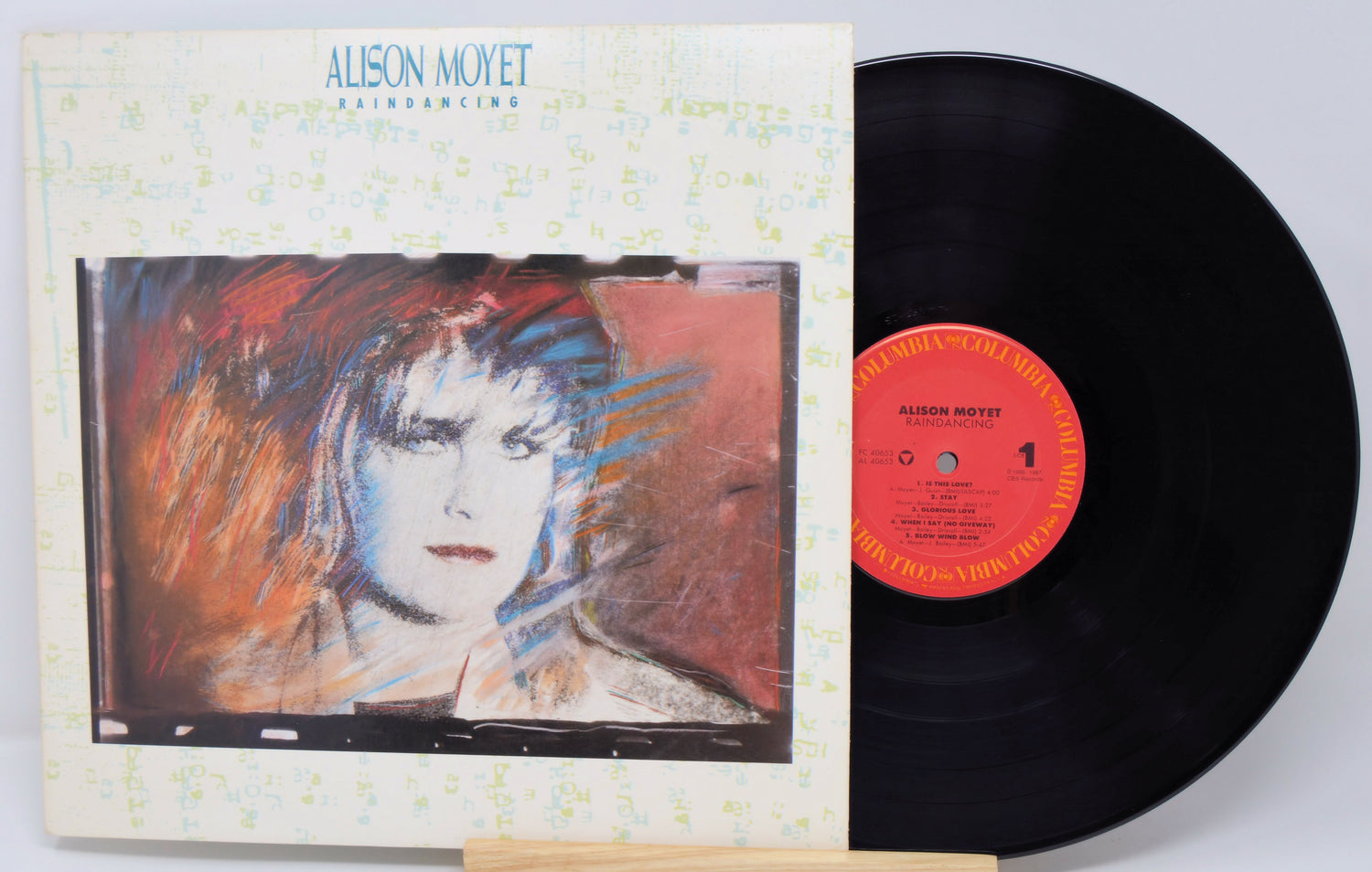 Vinyl record with cover featuring an artist's portrait and colorful abstract design.