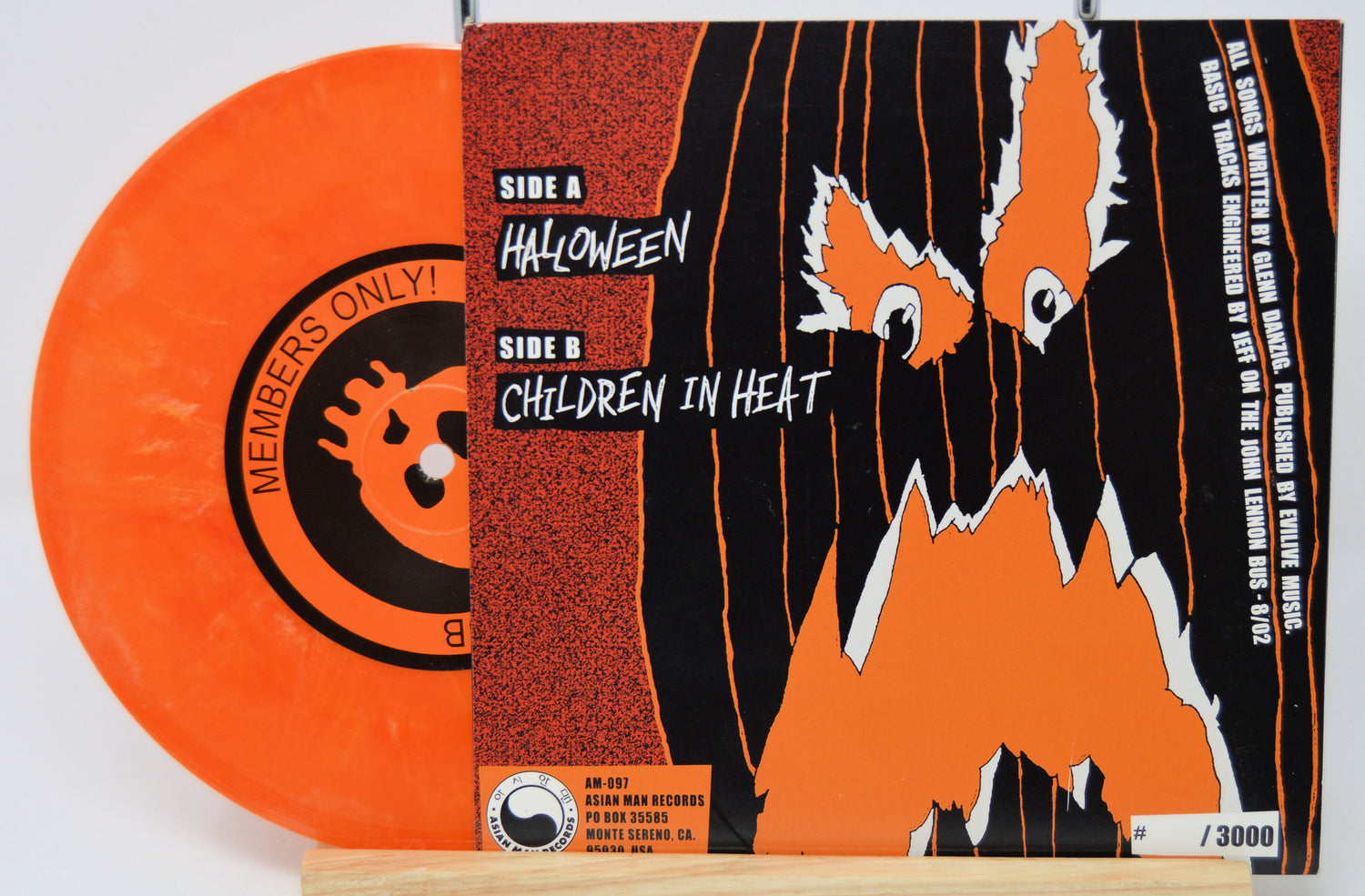 Vinyl record with orange disc and black and orange cover featuring a ghost design.