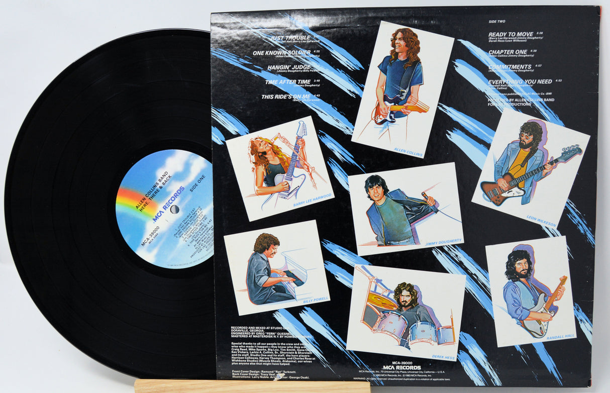 Vinyl record with a colorful cover featuring images of a person playing guitar and sitting.