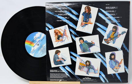 Vinyl record with a colorful cover featuring images of a person playing guitar and sitting.