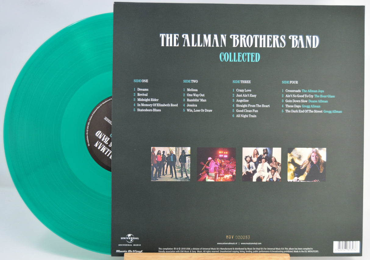 The Allman Brothers Band 'Collected' vinyl record album shown with the back of the black sleeve and a translucent green record partially visible on a white background.