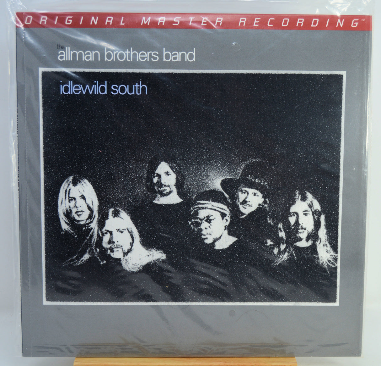 Allman Brothers Band 'idewild south' original master recording vinyl LP album cover, sealed in plastic shrink wrap, displayed on a wooden stand.
