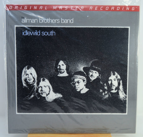 Allman Brothers Band 'idewild south' original master recording vinyl LP album cover, sealed in plastic shrink wrap, displayed on a wooden stand.