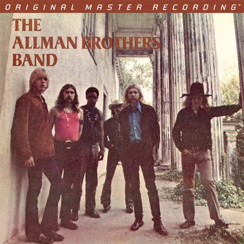 Album cover for 'Original Master Recording' featuring 'The Allman Brothers Band' standing in an outdoor architectural setting with stone columns. The band members are dressed in dark, casual 1960s/70s attire, and the text is printed in a warm brown tone against a muted beige and green background.