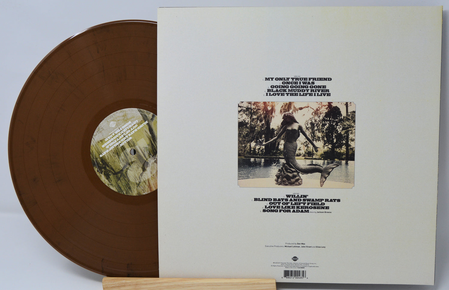 Brown vinyl record with a matching sleeve featuring album artwork and text.