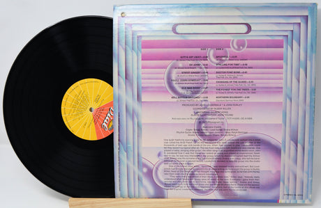 Vinyl record with a colorful cover featuring text and graphics.
