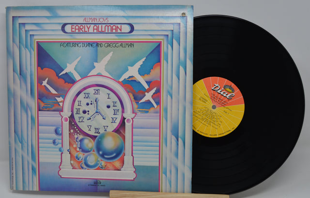 Vinyl record with colorful cover featuring a clock design and airplane illustrations.