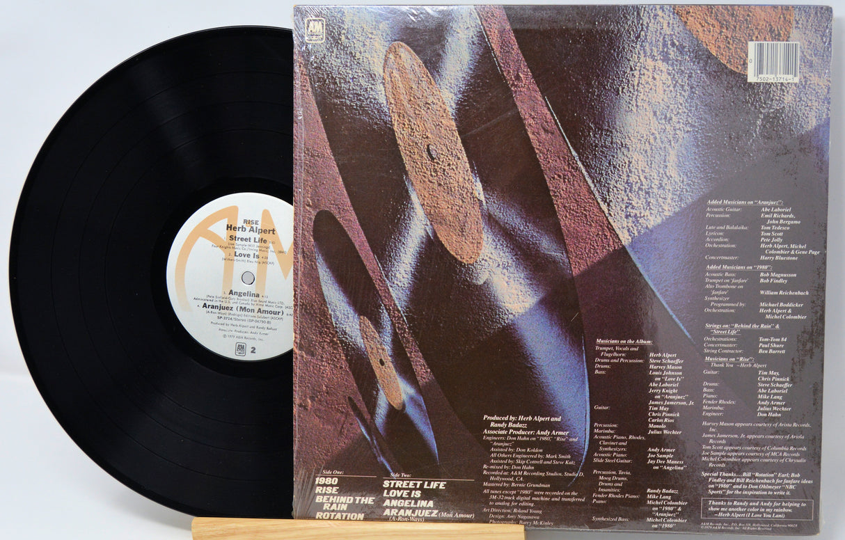 Vinyl record with cover featuring abstract design and text