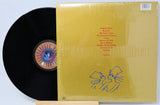 Vinyl record with yellow cover featuring a stylized illustration and text.