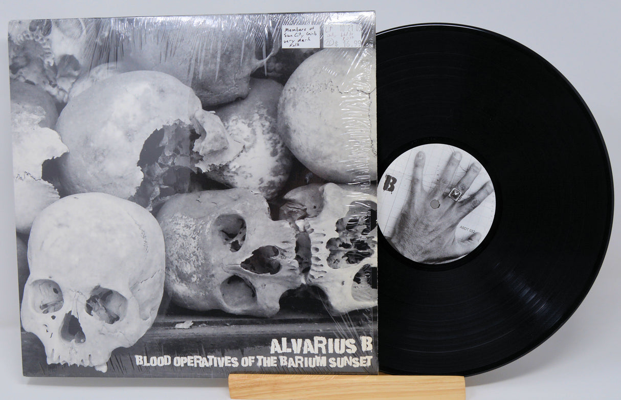 Vinyl record and cover art for Alvarius B album 'Blood Operatives Of The Barium Sunset' featuring a monochrome design with skulls.