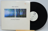 Fred Simon Usually/Always vinyl record with front cover featuring serene lakeside photography