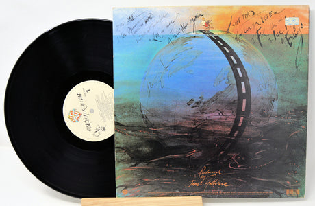 Vinyl record with a colorful album cover featuring a road around a planet.