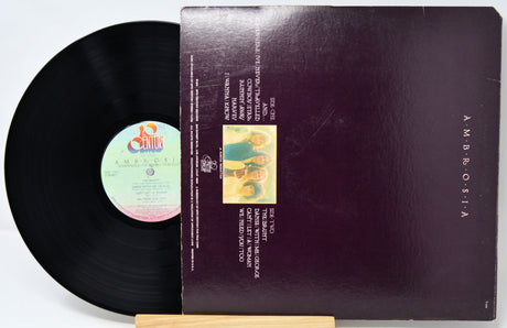Vinyl record with cover featuring text and images on a white background
