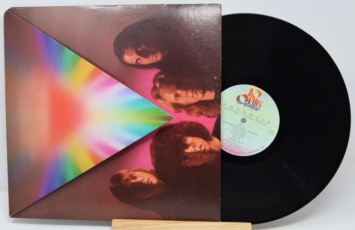 Vinyl record with a colorful cover featuring four faces and a rainbow design.