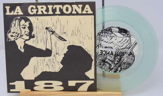 A clear vinyl record titled 'La Gritona 187' with a black and white cover design featuring a illustration of a person. The record is displayed next to its cover.