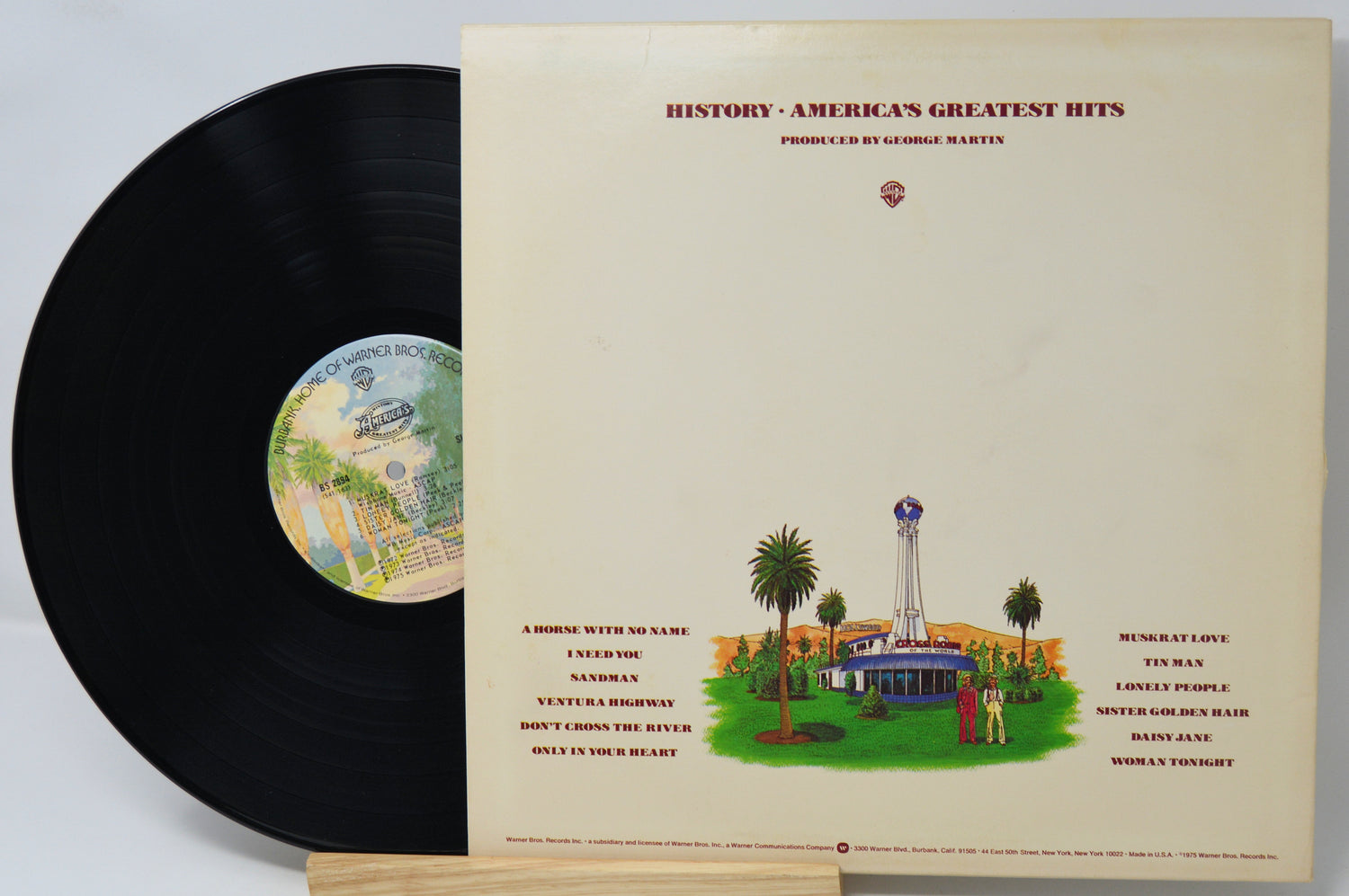Vinyl record with cover featuring a scenic illustration and text