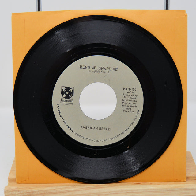 A vinyl record of American Breed - Bend Me, Shape Me / Step Out Of Your Mind, with a black label and orange text.