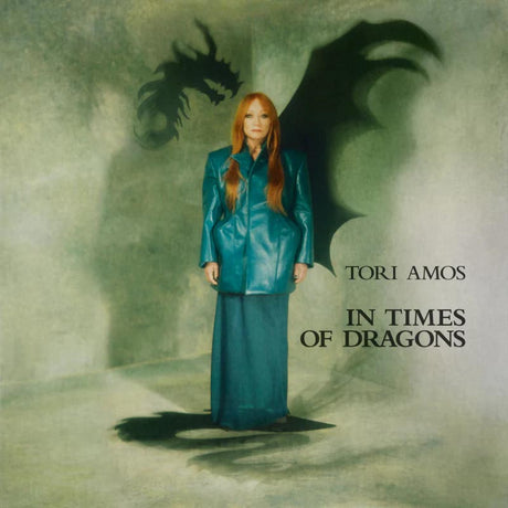 Album cover with a person in a teal outfit standing in front of a dragon's shadow