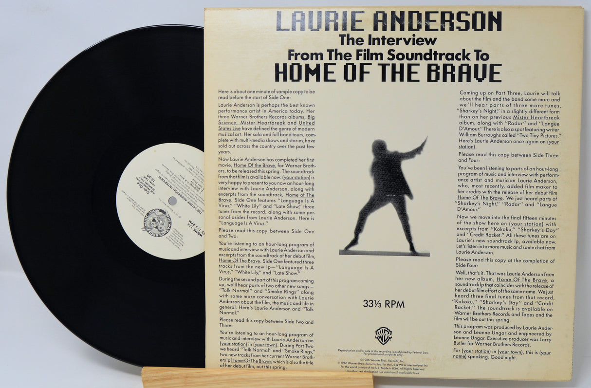 Vinyl record with its cover featuring text and a silhouette of a person.