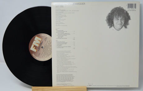 Vinyl record with cover featuring a person's face and text