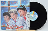 Front cover of Andrews Sisters Christmas vinyl album featuring the trio smiling in festive attire