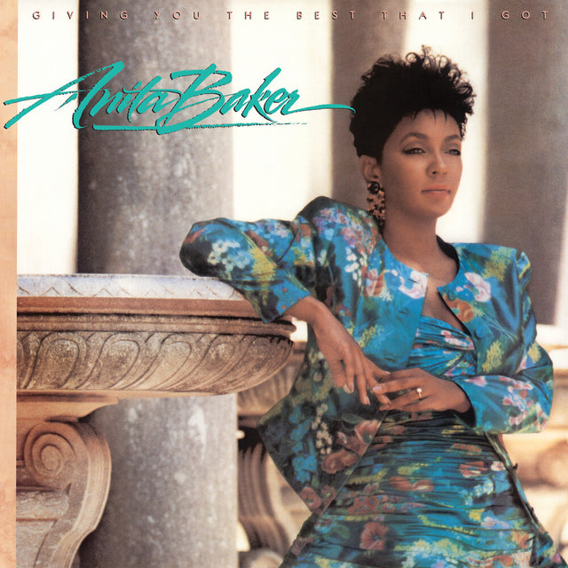 Album cover featuring a woman in a floral dress sitting on a stone bench with 'Anita Baker' text.