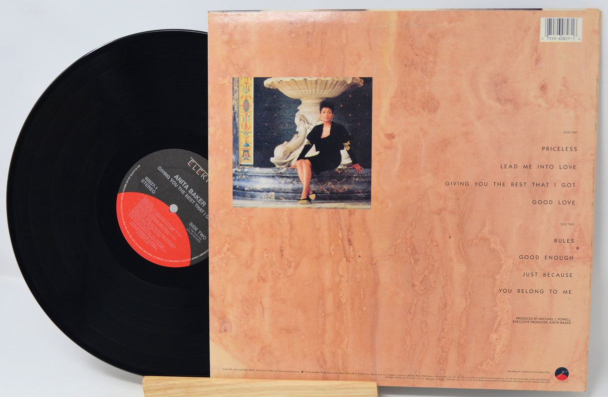 Vinyl record with a cover featuring an illustration of a woman in a black dress.