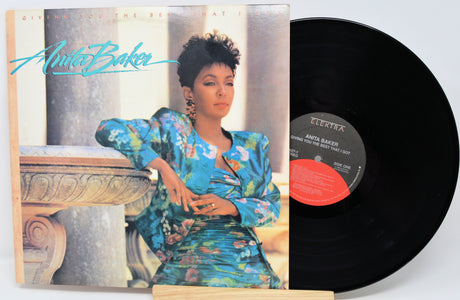 Vinyl record with cover featuring a woman in a floral dress, on a white background