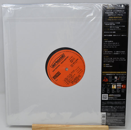The back of a vinyl record sleeve for Ann Burton's 'Hot Butter' 12-inch release, showing the black spine with Japanese text and a central orange label on a white background, wrapped in clear plastic.