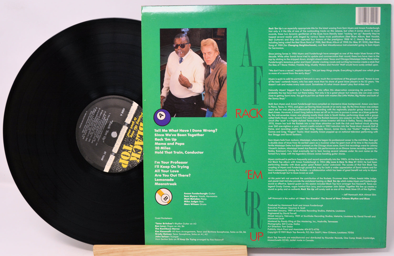 Vinyl record with green label featuring two people and text on a white background