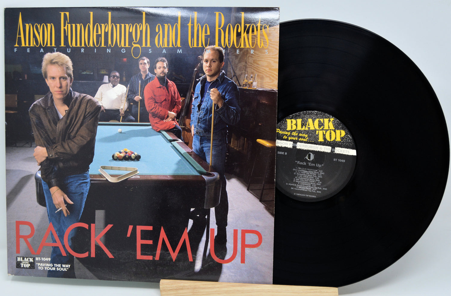 Vinyl record with cover featuring a pool table and people around it, titled 'Rack 'Em Up'.