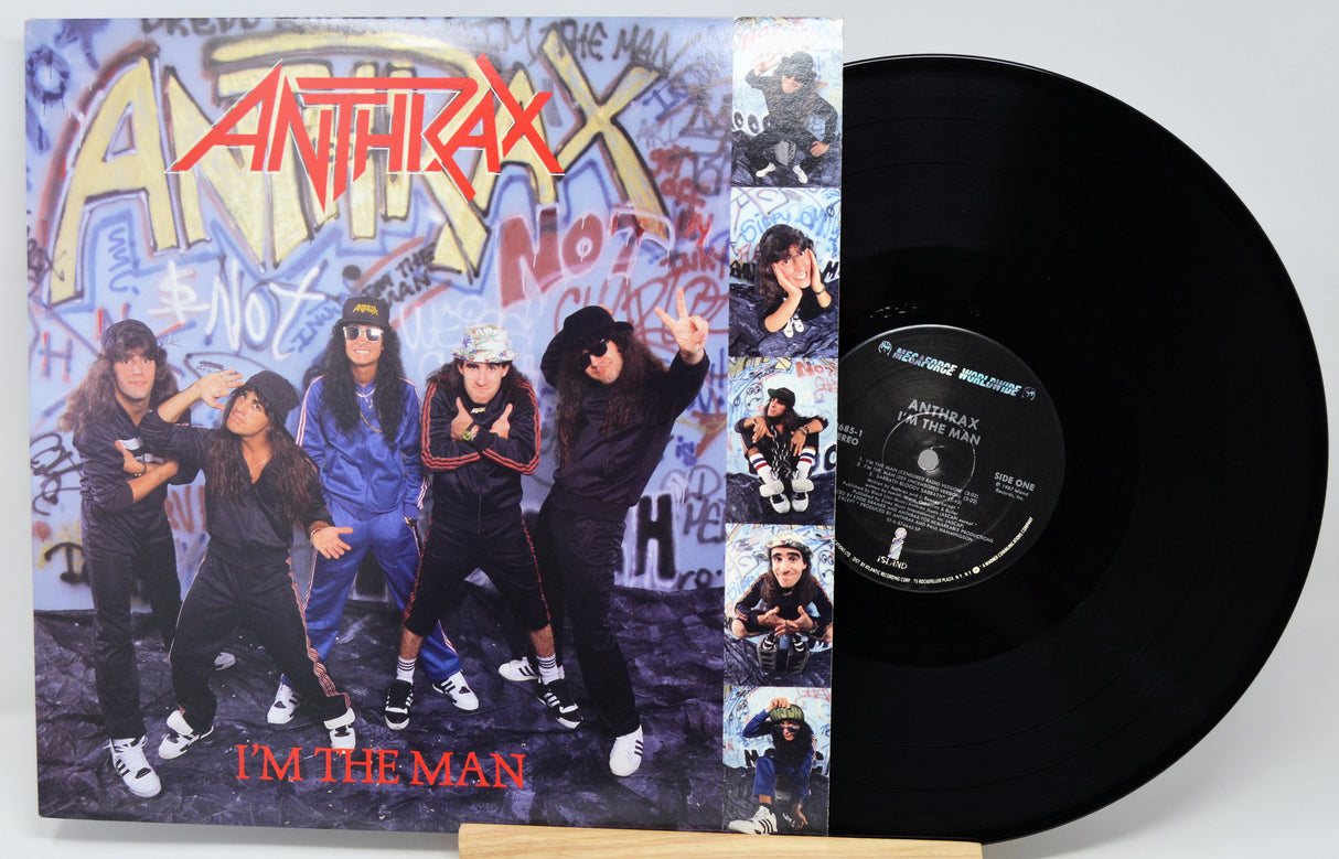 Anthrax vinyl record album 'I'm The Man' shown with the printed cover on the left and the black LP record partially pulled out on the right, photographed against a light gray background.
